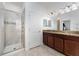 Bathroom featuring a glass door shower, granite countertop, and wood cabinets at 8924 Azalea Sands Ln # 8924, Davenport, FL 33896