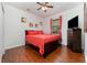 Bedroom with wood floors, a ceiling fan, and a large window with orange curtains at 8924 Azalea Sands Ln # 8924, Davenport, FL 33896