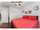 Bedroom with rich hardwood floors, ceiling fan, and a large bed with an orange quilt at 8924 Azalea Sands Ln # 8924, Davenport, FL 33896