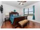 Relaxing bedroom with hardwood floors, a dark wood bed frame, and a window overlooking a grassy area at 8924 Azalea Sands Ln # 8924, Davenport, FL 33896