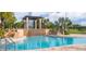 Beautiful community pool with waterfall feature and lush landscaping for a relaxing atmosphere at 8924 Azalea Sands Ln # 8924, Davenport, FL 33896