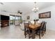Dining room with tile floors, dining table with 6 chairs, a fireplace, living room access, and sliding doors at 8924 Azalea Sands Ln # 8924, Davenport, FL 33896