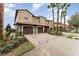 Charming townhomes feature a paved driveway, 1-car garage, and a tile roof, complemented by well-maintained landscaping and palm trees at 8924 Azalea Sands Ln # 8924, Davenport, FL 33896