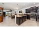 Spacious kitchen and dining area with stainless steel appliances, dark wood cabinets, and tiled flooring throughout at 8924 Azalea Sands Ln # 8924, Davenport, FL 33896