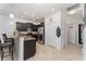 Modern kitchen features dark cabinets, stainless steel appliances, and a breakfast bar overlooking the adjacent rooms at 8924 Azalea Sands Ln # 8924, Davenport, FL 33896