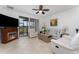 Bright living room with a fireplace, comfortable seating, and a ceiling fan at 8924 Azalea Sands Ln # 8924, Davenport, FL 33896