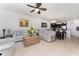 Open concept living room flows into kitchen with dark cabinets and a dining area with a chandelier and art at 8924 Azalea Sands Ln # 8924, Davenport, FL 33896