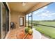 Screened patio with views of the golf course, stylish furniture, and a tiled floor for outdoor enjoyment at 8924 Azalea Sands Ln # 8924, Davenport, FL 33896