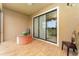 A cozy tiled patio with comfortable seating and sliding glass doors overlooking a lush outdoor view at 8924 Azalea Sands Ln # 8924, Davenport, FL 33896