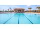 Resort style community pool with lap lanes, poolside bar, and lounge chairs for relaxation and recreation at 8924 Azalea Sands Ln # 8924, Davenport, FL 33896