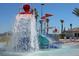 Community waterpark featuring colorful waterslide, shallow pool, and water bucket splash zone for Gathering fun at 8924 Azalea Sands Ln # 8924, Davenport, FL 33896