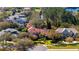 Aerial view of a community highlighting meticulously maintained homes with beautiful landscaping nestled amongst mature trees and a lake at 9212 Island Lake Ct, Orlando, FL 32836