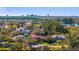 Community aerial view featuring lake views, lush trees, and spacious homes in a desirable location with city skyline at 9212 Island Lake Ct, Orlando, FL 32836
