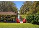 Waterfront backyard featuring deck with seating and boat house on a serene waterway surrounded by lush greenery at 9212 Island Lake Ct, Orlando, FL 32836