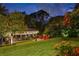 Picturesque backyard with a cozy boathouse, seating area, and manicured lawn creates an inviting outdoor space at 9212 Island Lake Ct, Orlando, FL 32836