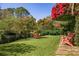 Lush backyard featuring a boathouse, seating area, and expansive lawn perfect for relaxation and recreation at 9212 Island Lake Ct, Orlando, FL 32836