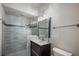 This stylish bathroom has a glass-enclosed tiled shower, modern vanity, and a towel rack at 9212 Island Lake Ct, Orlando, FL 32836