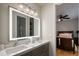 This modern bathroom boasts a double vanity with a stylish backlit mirror, and is adjacent to the main bedroom at 9212 Island Lake Ct, Orlando, FL 32836