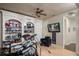 This bonus room has built-in shelving, a TV, a comfortable chair, and a door to another room at 9212 Island Lake Ct, Orlando, FL 32836