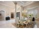 Elegant dining room with marble floors, designer lighting, and seating for six, great for hosting at 9212 Island Lake Ct, Orlando, FL 32836