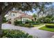 Charming two-story home with a red-tiled roof, manicured landscaping, and a welcoming driveway at 9212 Island Lake Ct, Orlando, FL 32836