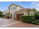 Beautiful exterior with a terracotta roof and a large two-car garage and meticulously manicured landscaping at 9212 Island Lake Ct, Orlando, FL 32836