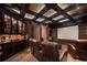 Dark and cozy home theater equipped with comfortable seating and a large screen for immersive entertainment at 9212 Island Lake Ct, Orlando, FL 32836