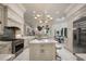 Spacious white kitchen with marble countertops, stainless steel appliances, a central island, and adjacent breakfast area at 9212 Island Lake Ct, Orlando, FL 32836