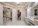 Luxurious main bathroom with marble countertops, double sinks, and access to a walk-in closet and bedroom at 9212 Island Lake Ct, Orlando, FL 32836