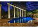 Stunning indoor pool features columns, glass roof, and lush landscaping for a serene and luxurious experience at 9212 Island Lake Ct, Orlando, FL 32836