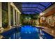 Spectacular indoor pool with a glass roof, pillars, waterfall, and poolside bar for the ultimate in relaxation and entertainment at 9212 Island Lake Ct, Orlando, FL 32836