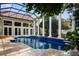 Gorgeous enclosed pool area featuring blue tile, columns, and natural stone decking at 9212 Island Lake Ct, Orlando, FL 32836