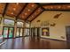 Large recreation room with hardwood floors, vaulted wood plank ceilings, and access to the outdoor pool area at 9212 Island Lake Ct, Orlando, FL 32836