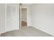 Neutral bedroom with carpeted floors, closet and a view into a tiled hall at 9868 Flynt Cir, Orlando, FL 32825