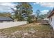 Backyard featuring a grass area, fire pit, and a white fence surrounding the space at 105 Morning Glory Dr, Lake Mary, FL 32746