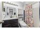 Cozy bathroom featuring tile flooring, a shower-tub combo, and a modern sink with sleek fixtures at 105 Morning Glory Dr, Lake Mary, FL 32746