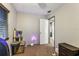 Bedroom with a cat tree and minimal furniture, leading to a hallway through an open door at 105 Morning Glory Dr, Lake Mary, FL 32746