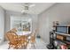 Bright dining area with natural wood table and chairs, lit by a ceiling fan at 105 Morning Glory Dr, Lake Mary, FL 32746