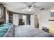 Spacious bedroom with a large bed, ceiling fan, natural light, and neutral decor at 105 Morning Glory Dr, Lake Mary, FL 32746