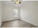 Bedroom features wood-look floors, a ceiling fan, and a window at 10525 Satinwood Cir, Orlando, FL 32825