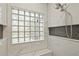 Close-up of walk-in shower details including tile, shelving, and shower head at 10525 Satinwood Cir, Orlando, FL 32825