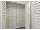 Organized walk-in closet with shelving and hanging storage at 10525 Satinwood Cir, Orlando, FL 32825