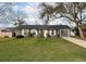 Charming single-story home with mature trees and a well-maintained lawn at 1067 Lyric Dr, Deltona, FL 32738