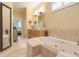 Bright bathroom featuring a bathtub with jets, perfect for relaxing and unwinding at 10819 Woodchase Circle, Orlando, FL 32836