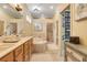 Bright bathroom featuring double sinks, a bathtub and shower, offering a luxurious space at 10819 Woodchase Circle, Orlando, FL 32836