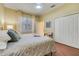 Bedroom featuring neutral walls, wood floors, and white closet doors at 10819 Woodchase Circle, Orlando, FL 32836