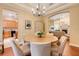 Bright dining room with a round table and seamless transition to the living room and kitchen at 10819 Woodchase Circle, Orlando, FL 32836