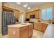 Bright kitchen with stainless steel refrigerator and island with white countertop at 10819 Woodchase Circle, Orlando, FL 32836