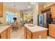 Bright open kitchen looking into the dining and living rooms, stainless steel appliances, island at 10819 Woodchase Circle, Orlando, FL 32836