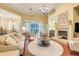 Inviting living room featuring a fireplace, comfortable seating, and sliding glass doors to the patio at 10819 Woodchase Circle, Orlando, FL 32836